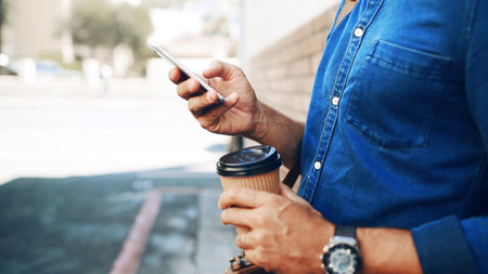 Coffee, hands and phone with business man on city street to search for directions information. Commute, social media or message with employee person outdoor on downtown sidewalk for travel to workの写真素材