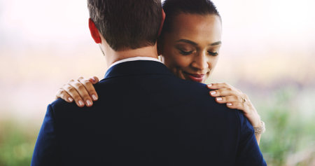 Couple, wedding or marriage with hug for love, commitment or embrace at romantic ceremony. Man, woman or bride and groom with smile, safety or security for care, support or comfort together in natureの写真素材