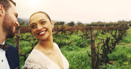 Wedding, smile and love with couple in nature for celebration, support and happy. Marriage ceremony, partner and commitment with man and woman walking in countryside for romance and eventの写真素材