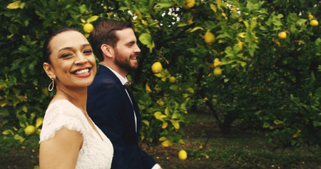 Walking, couple and smile for wedding, nature and romance for newlyweds, man and bonding with woman. Outdoor, bride and love for groom, portrait and happy for marriage, care or people with commitmentの写真素材
