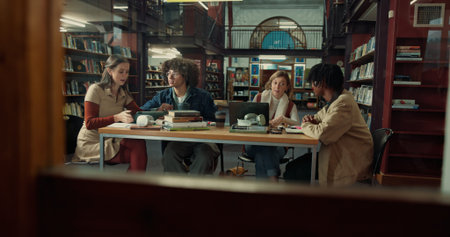 Talking, books and group of students studying in library for university test, project or exam....