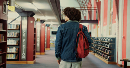 Walking, research and back of man in library for learning, university project or study resources....