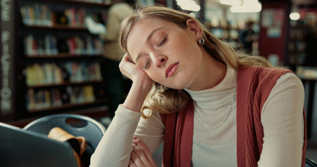 College student, laptop and girl with sleeping in library for study fatigue, burnout or low energy....
