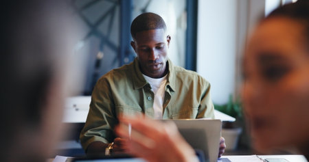 Coworking, laptop and planning with business man in office for administration, report or research. Computer, development and review with employee reading online information or knowledge in workplaceの写真素材