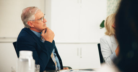 Business man, boardroom or listen in presentation for finance pitch, funding request and feedback. Financial stakeholders, mature person and discussion in office for investment briefing and proposalの写真素材