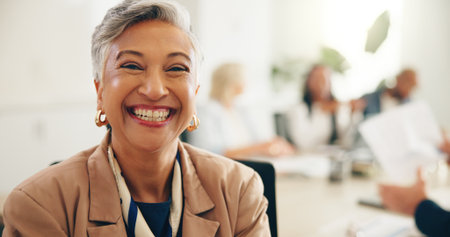 Portrait, mature and happy businesswoman in office for coworking at insurance meeting. CEO, smile or confident leader with corporate executive, risk manager or professional coverage advisor with teamの写真素材