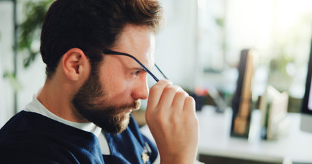 Tired, nurse and man with glasses, hospital or unhappy with pressure, administration and eye strain. Healthcare, medical assistant and person with computer vision syndrome, exhausted and burnoutの写真素材
