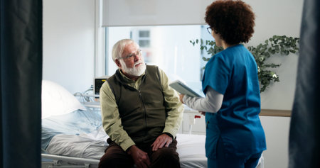 Consultation, hospital and nurse with senior man for healthcare support, help or discussion. Tablet,...
