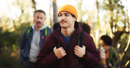 Hiking, nature and man with friends with activity, journey or adventure on outdoor vacation. Walking, woods and people with trekking together for hobby, exploring or travel in forest on holiday.の写真素材