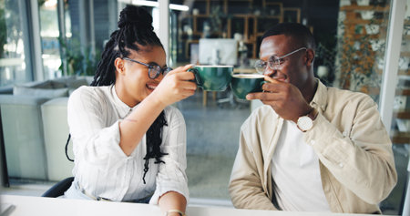 Coffee, teamwork and cheers with business people in office for caffeine break, collaboration or success. Partnership, drinking tea and achievement with African employees in agency for toast on profitの写真素材