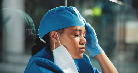 Tired, woman and healthcare with doctor in hospital for surgery error, patient death and depression....