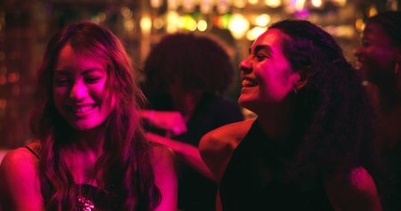 Girl, dancing and happy with friends at nightclub with celebration, party and social event at bar. People, women and smile with rhythm, culture and excited with music for new years eve at restaurantの写真素材