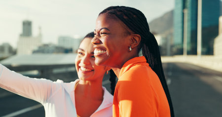 Fitness, friends and happy women with selfie in city for social media post with sports influencer. Picture, smile and runner team outdoor for photo on street, memory or bonding together for wellnessの写真素材