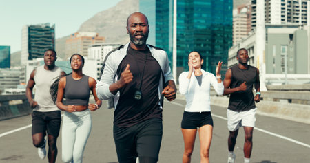 Coach, group and running in city, fitness and motivation for marathon training with speed on bridge. Mentor, people and outdoor on urban street for cardio workout, exercise and challenge in townの写真素材