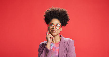 Thinking, business and woman in studio, decision and fashion designer on red background. Glasses,...