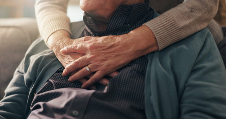 Hug, hands and elderly couple in home, bonding and affection for relationship in lounge and comfort....