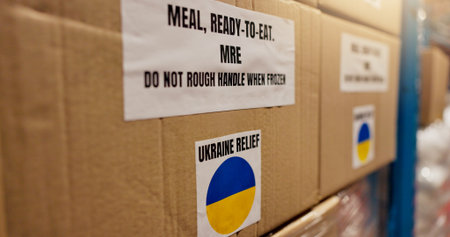 Shipping, Ukraine and charity with box in warehouse for logistics, food package and donation. NGO distribution, war crisis and humanitarian aid with cargo in factory for social responsibilityの写真素材