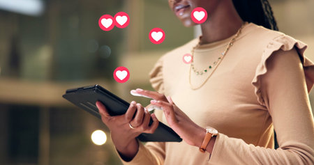 Hands, person and tablet with emoji in office for social media, like post and reactions at night. Woman, digital and overlay icons of app interaction, comments and share notification for working lateの写真素材