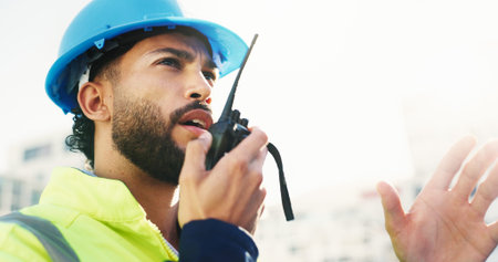 Construction site, radio and man with engineering, conversation and inspection with quality control....