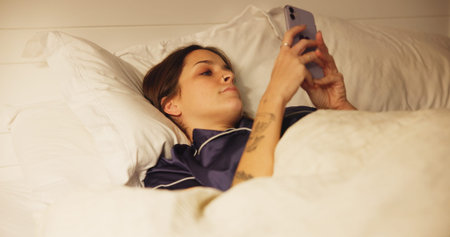 Woman, bed and relax with smartphone for communication, text or online chat. Typing, connection and...