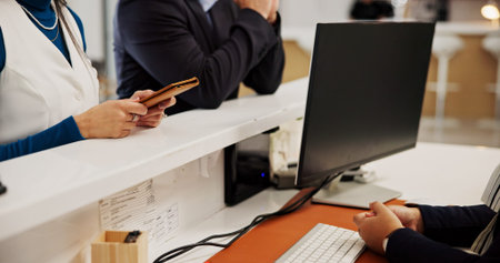 Hands, passport and concierge at hotel, computer and welcome for booking with blank screen for...
