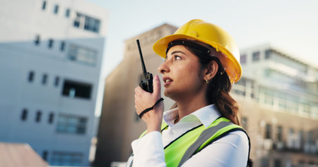Woman, engineer and talk on radio outdoor for discussion, planning and construction advice. Person,...