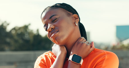 Fitness, workout and black woman in city with neck pain, injury or accident with running or training. Sports, discomfort and athlete with muscle sprain, inflammation or bruise for cardio exercise.の写真素材