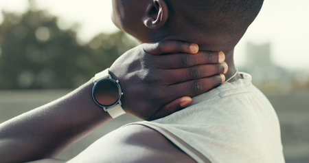 Neck pain, hand or black man in city for fitness, muscle fatigue or discomfort from burnout. Athlete, outdoor or joint ache with tension from accident injury, overexertion or sprain with inflammationの写真素材