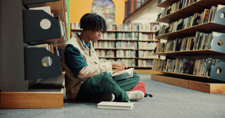Student, books and floor with black man in library for reading, assignment and college thesis....