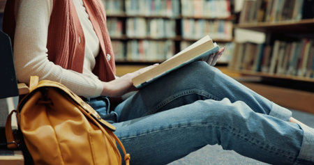 Student, books and reading with woman in library for research, assignment and college thesis....