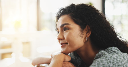 Woman, happy and thinking on couch in home for daydream, nostalgia and memory in lounge. Person,...