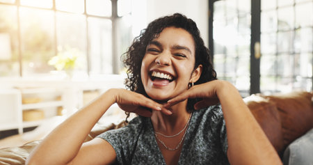 Portrait, happy and woman laugh at house for peace, calm morning and weekend break in lounge. Smile, female person and good mood on day off, positive attitude and funny joke for cosy wellness on sofaの写真素材