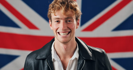 Laughing, native and portrait of happy man with British flag, confidence and country loyalty. Britain, funny joke or proud person with United Kingdom symbol for nationality, citizenship or patriotismの写真素材