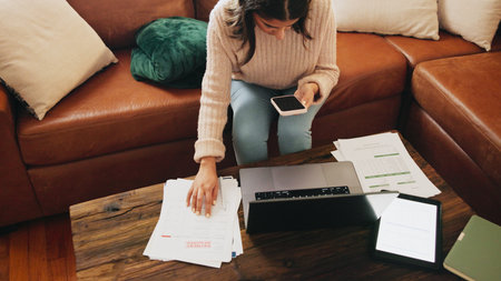 Woman, finance and smartphone in home for documents, debt or above with fintech for easy payment on sofa. Person, phone and mobile app with interest for loan, bills and balance with banking at houseの写真素材