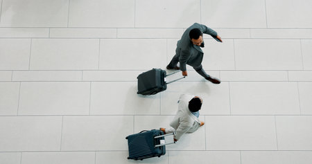 Businessmen, walking and travel with suitcase above for corporate commute or job opportunity. Top view, male people or employees with luggage for career migration, business trip at airport on spaceの写真素材