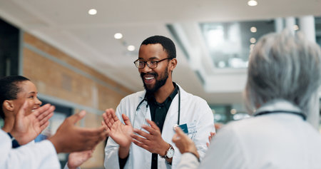 Applause, doctor and group with smile, hospital and celebration for success, healthcare and meeting. Happy, medical professional and people with achievement in clinic, clapping and win for teamの写真素材
