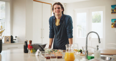 Kitchen, portrait or happy man on tablet for cooking recipe method, lunch or guide in home. Online tutorial, confident or person on touchscreen with ingredients instruction, food or meal prep stepsの写真素材