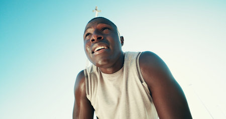 Fitness, tired and black man on break with sweat outdoor for health, wellness and exhausted. African...