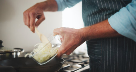 Kitchen, pan and hands with onions for meal prep, entrepreneur or ingredients for cuisine or dinner. Cooking, chef and person with culinary skills for catering business, process and recipe for dishの写真素材