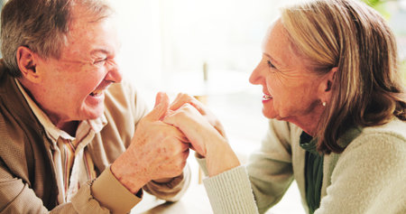 Love, holding hands and smile with old couple in home for romance, bonding and anniversary. Happy,...