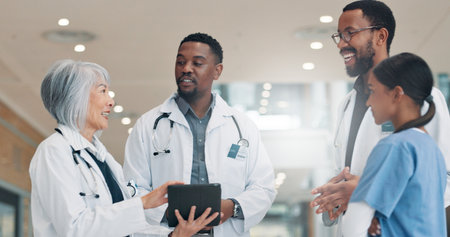 Doctors, tablet and group in hospital, healthcare and conversation with teamwork. Employees, medical service and professional in clinic, tech and feedback for diagnosis, talking and app for scheduleの写真素材