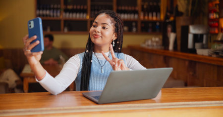 Selfie, peace sign and student in coffee shop with smile for social media, online post and internet....