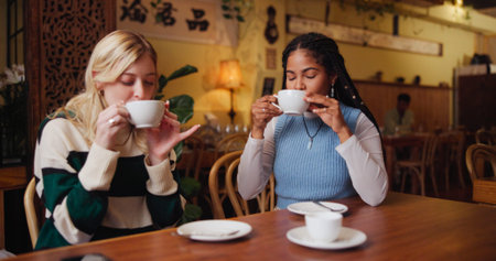 Women, friends and drink in coffee shop for break, reunion or bonding together. Girls, customer and...