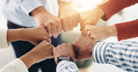 Fist bump, hands together and team of business people with mission, support and solidarity for...