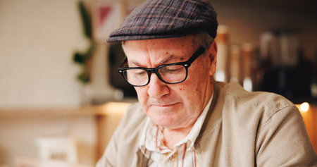 Break, face and glasses with old man in coffee shop to relax for retirement, service or wellness....