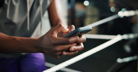 Fitness, man hands and phone in boxing ring for contact, training schedule or typing message on...