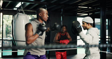 Gym, fitness and training with people in boxing ring for sports, self defense or sparring. Boxer,...