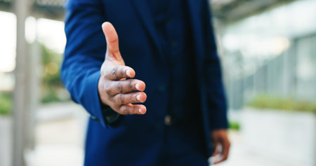 Business person, handshake and meeting with introduction for greeting, partnership or deal in city. Closeup, employee or recruiter shaking hands with gesture or agreement for hiring or recruitingの写真素材