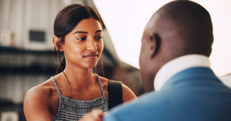 Getting ready, production and stylist in studio with model for photography session or shoot. Behind the scenes, preparation or styling with man and woman on set together for filming or videographyの写真素材