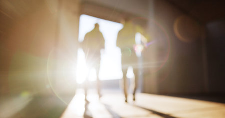 Blur, building and flare with construction worker people on site for collaboration or civil engineering. Architecture, back and infrastructure with contractors on location for industrial developmentの写真素材